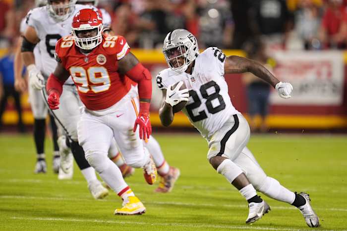 Oct 10, 2022; Kansas City, Missouri, USA; Las Vegas Raiders running back Josh Jacobs (28) runs the ball in the first half against the Kansas City Chiefs at GEHA Field at Arrowhead Stadium. Mandatory Credit: Jay Biggerstaff -USA TODAY Sports